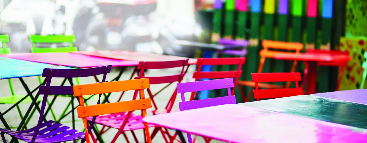 Bright colorful tables of an empty Parisian outdoor cafe on Montmartre